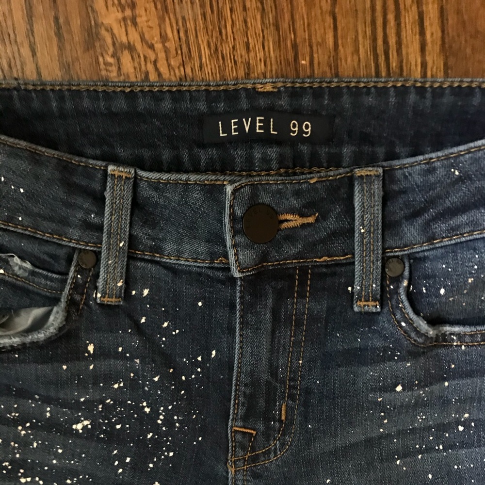 Level 99 raw hem, splattered skinny jeans